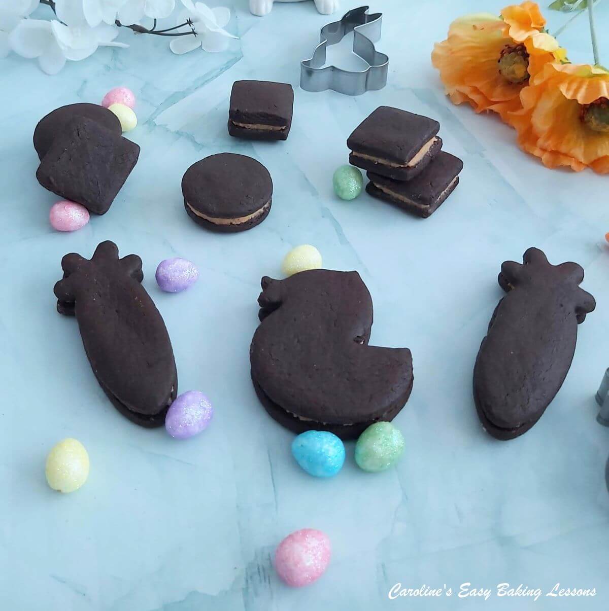 Easter shaped chocolate cookies with cutters, mini easter eggs and flowers.