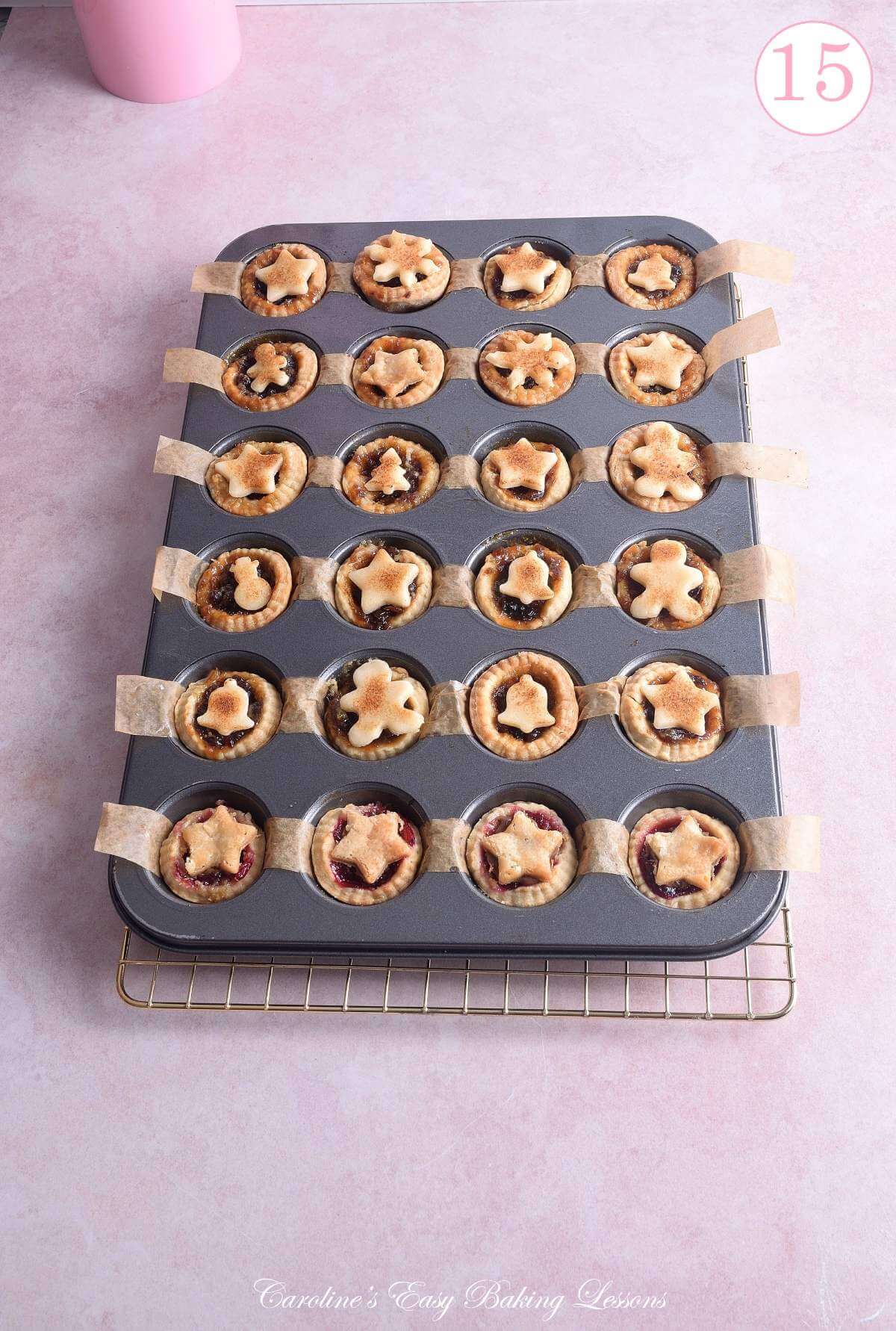 Image of a 24-hole mini muffin tin with mini mince pies baked and cooling with text 'photo 15'.