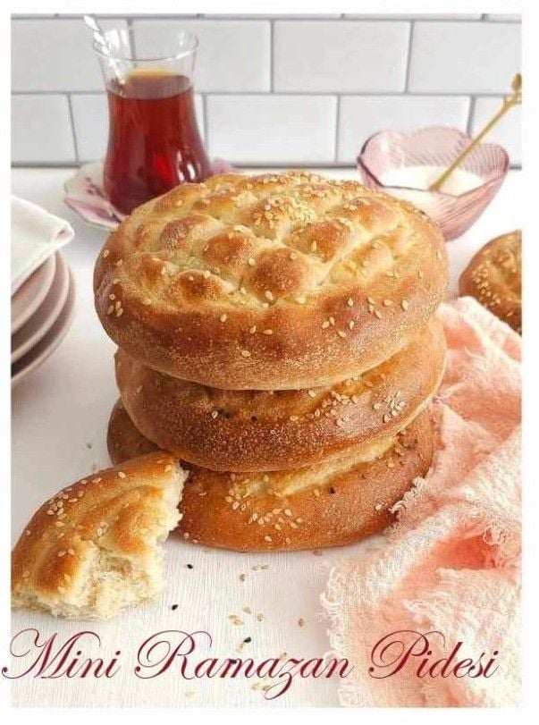 Front shot of a stack of smaller Turkish pide, thick diamond patterned topped flatbread.