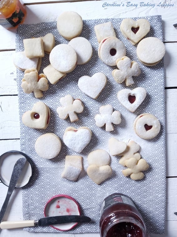working on sugaring and jaming sandwich cookies overhead shot
