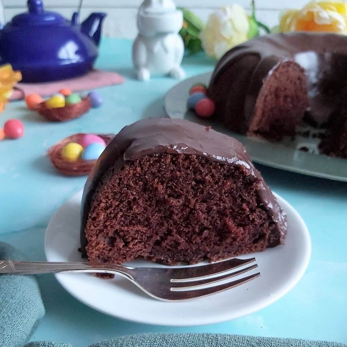 Slice of chocolate devils food bundt cake up close served.