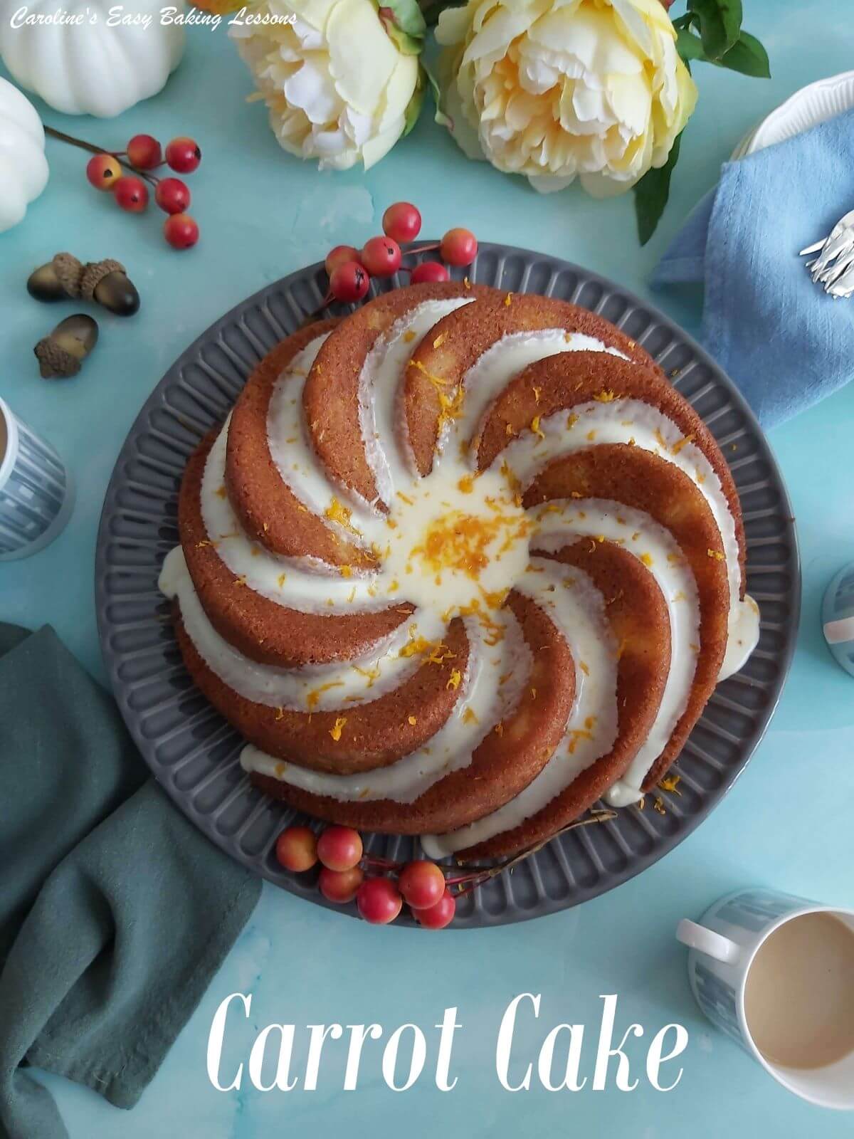 Overhead shot of a carrot cake baked in a budt pan with cream cheese frosting down the groves and set on a dinning table with titel.