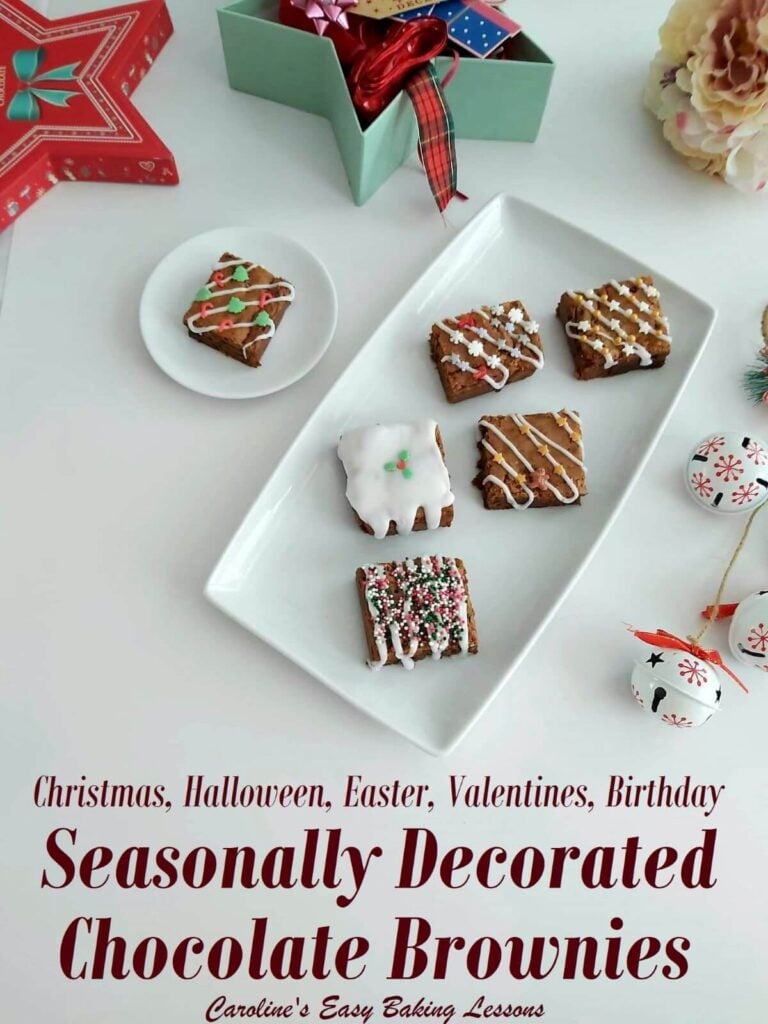 overhead photo on white table with Christmas decorations and wrapping, with plate of decorated brownie squares and title seasonally decorated brownies.
