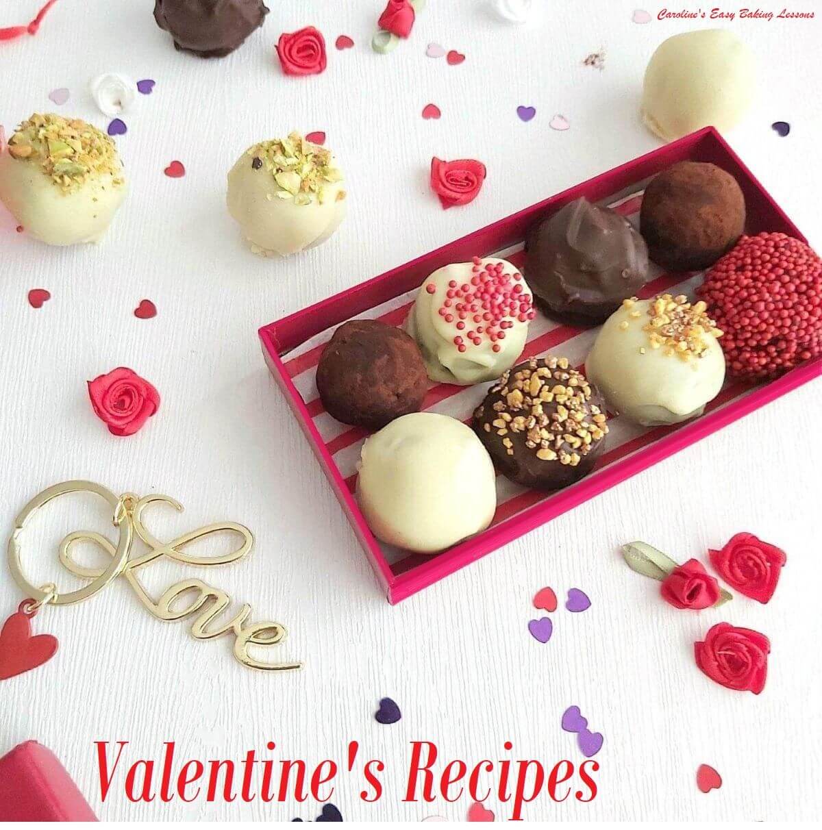 bright white table with red small rectangular box of 8 cake truffles, some on the table and red sprinkles and love keyring and title valentines recipes.