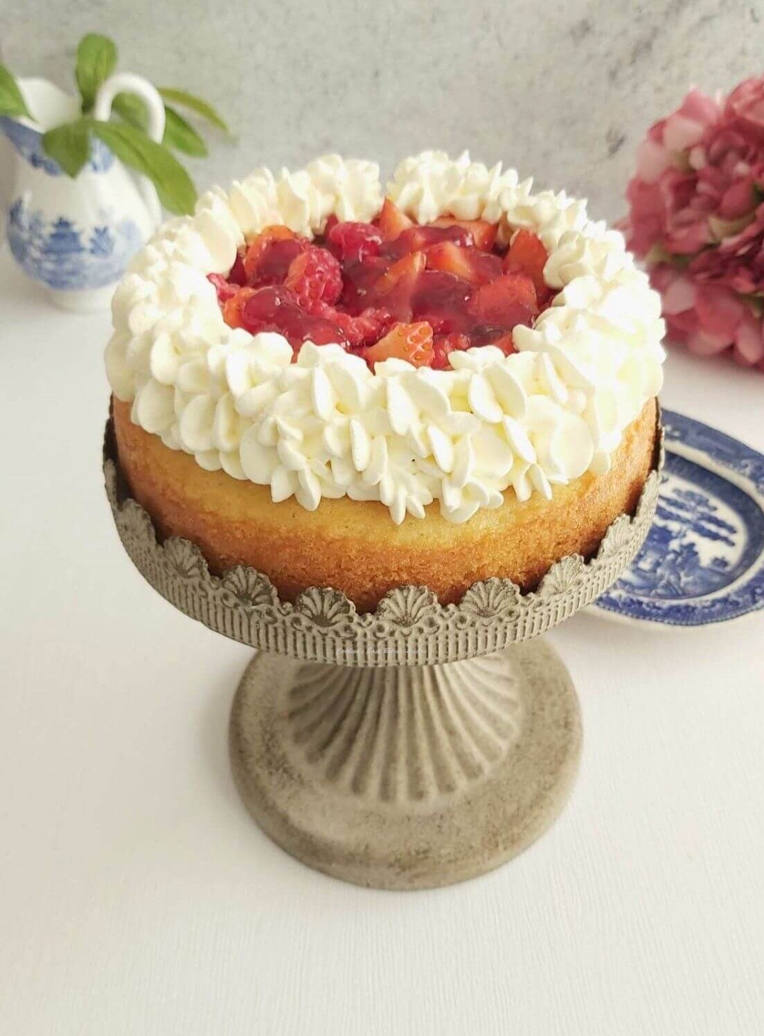 Photo of single layer of Victoria Sandwich cake, with tall piped cream ring and chopped raspberrie sin centre, on a small cake stand - photo 12.
