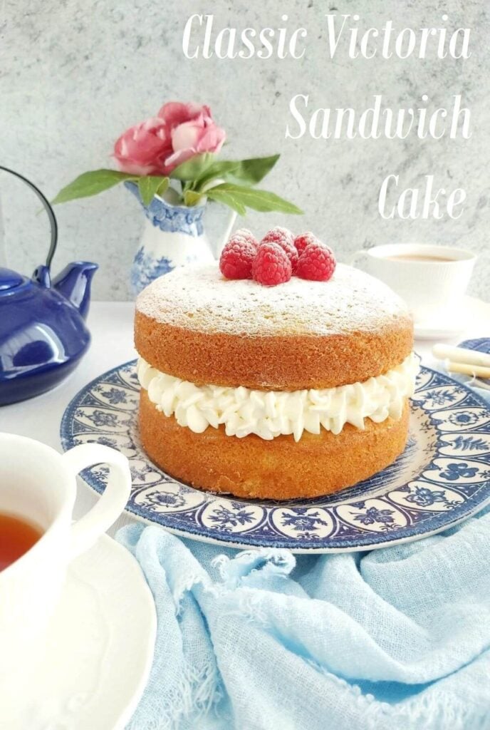 Victoria sandwich cream filled layer cake on fancy blue plates and text.