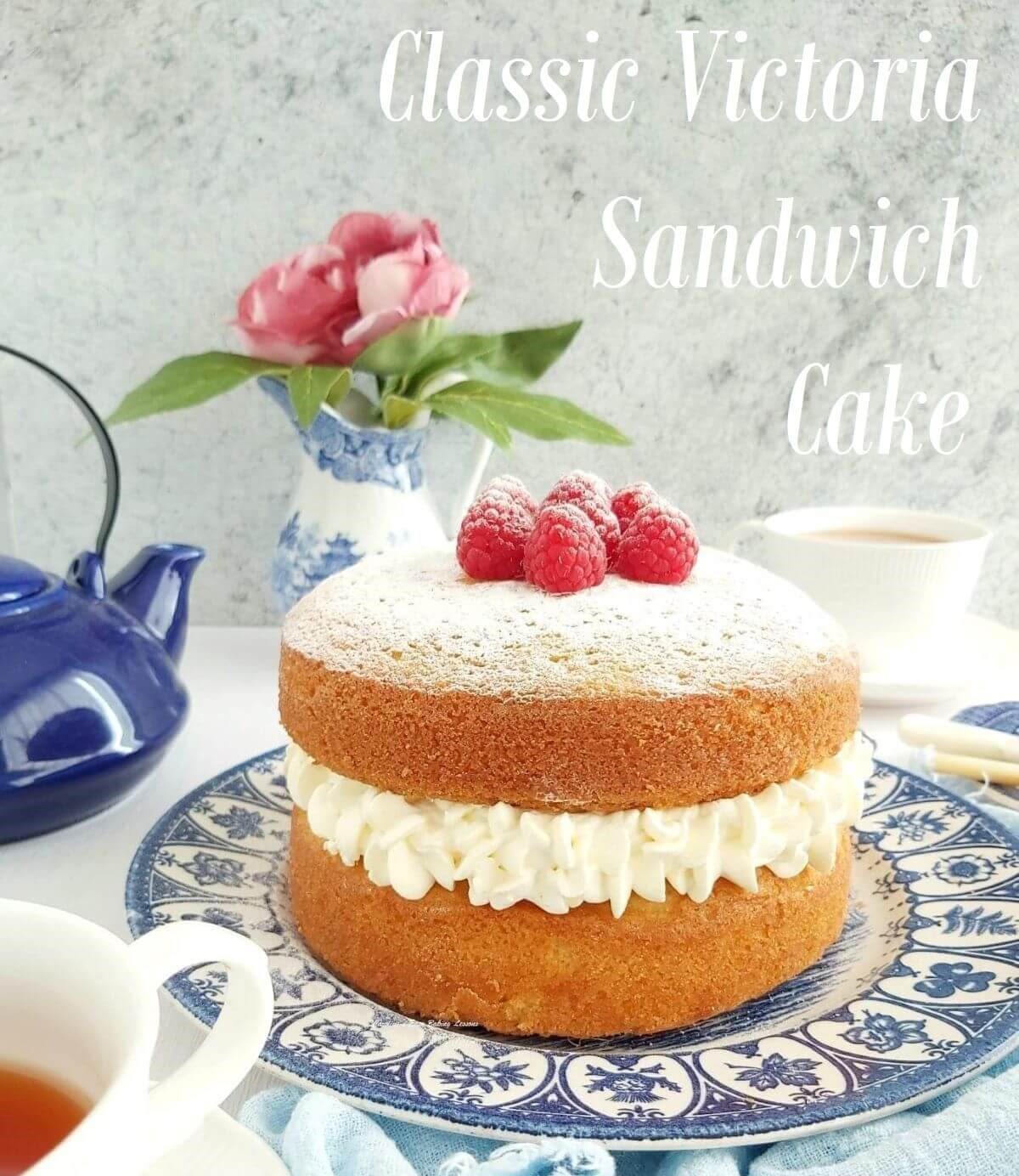 Victoria sandwich cream filled layer cake on blue plate and text croped.