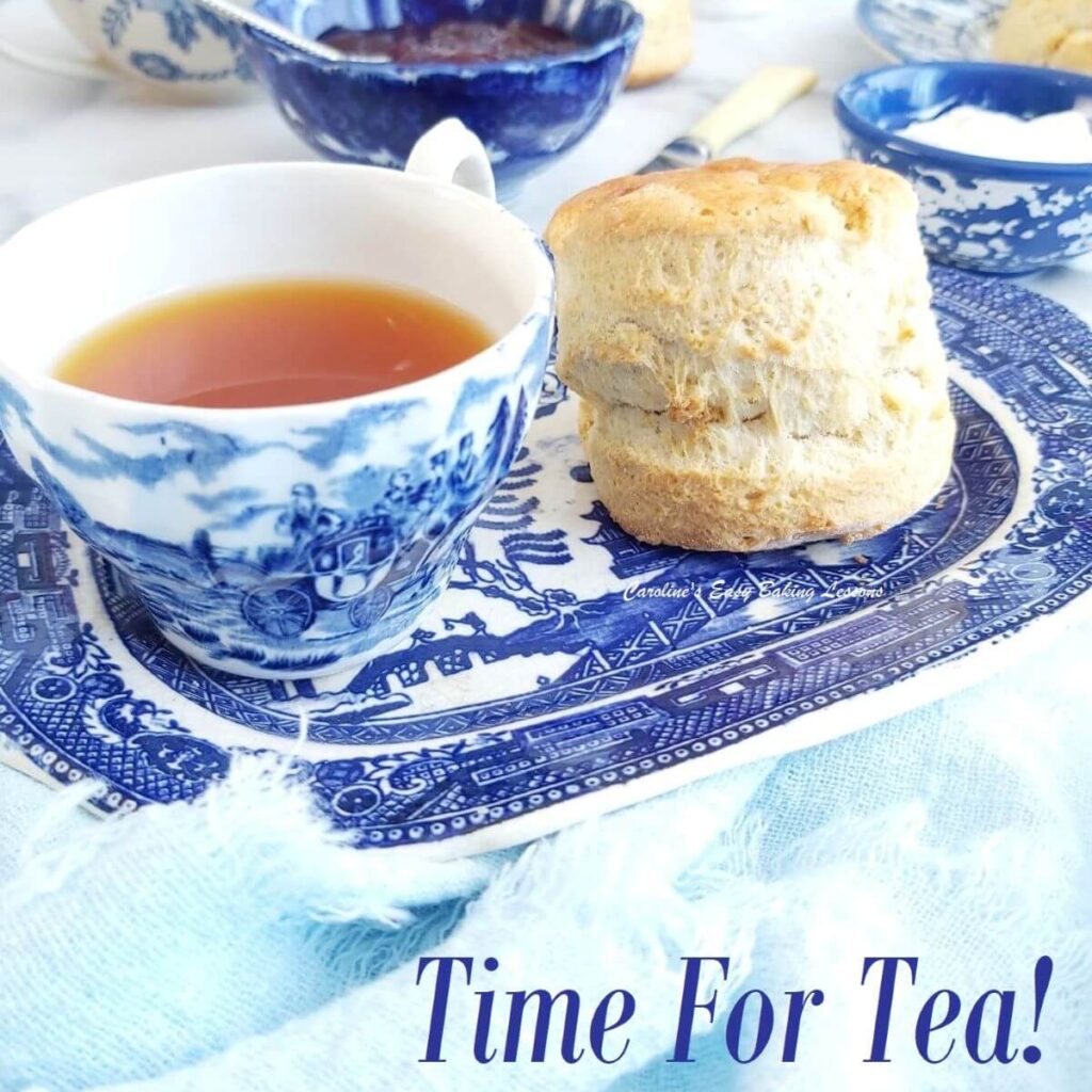 Front on close photo of blue and white Willow crockery, with tea cup ans British scone, and text 'Time For Tea'.