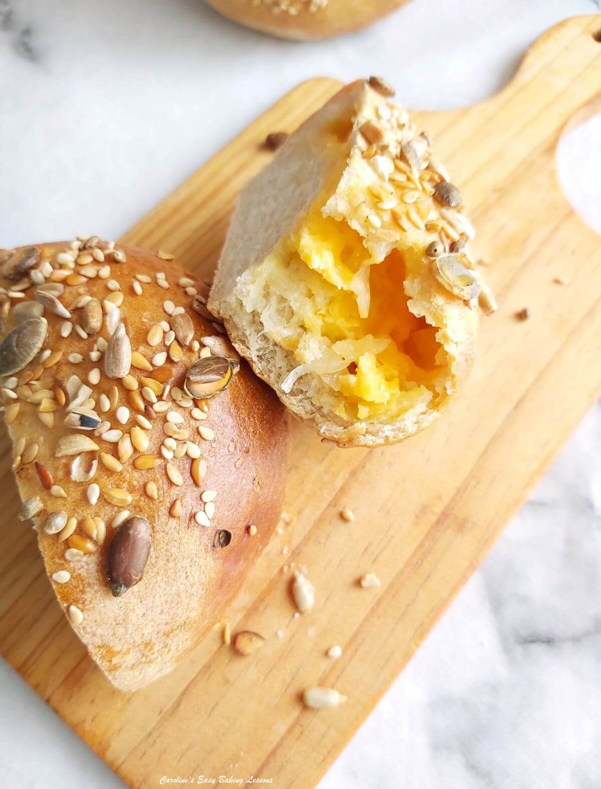Close shot of 2 pieces of cheddar filled Turkish Poĝaça roll.