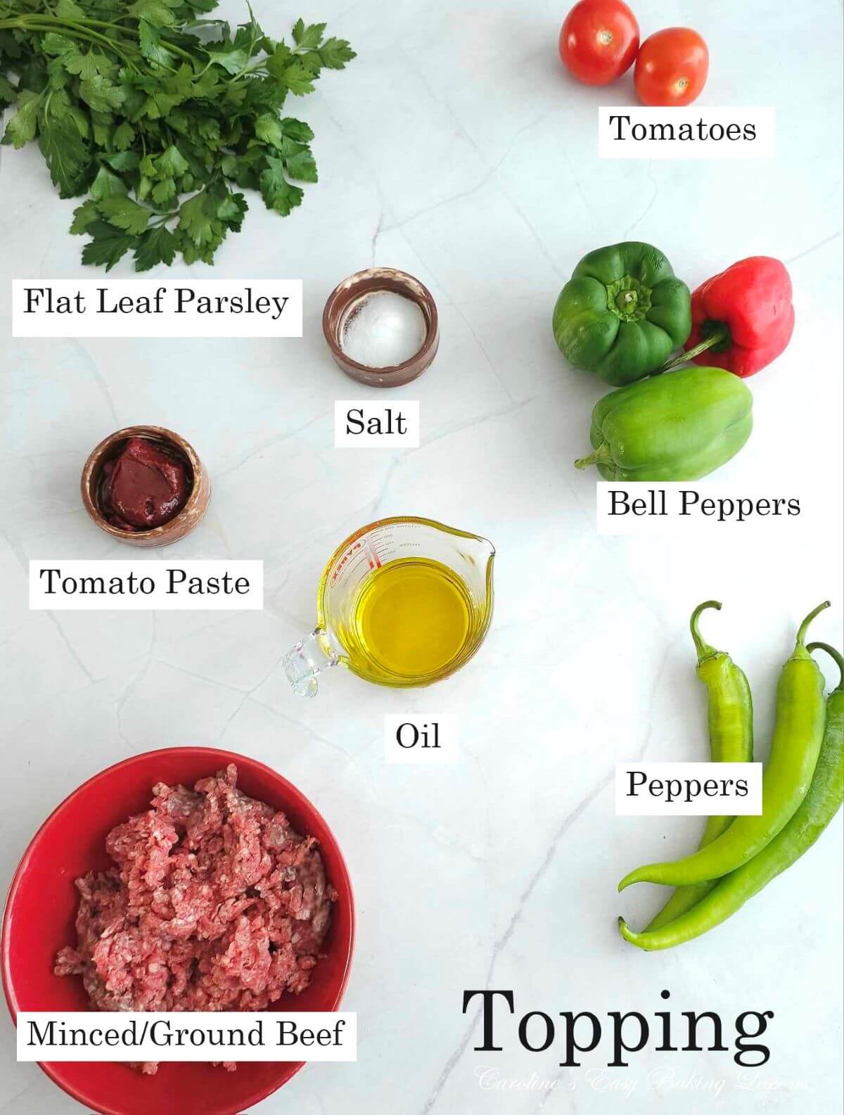 Overhead photo of table top with bowls and ingredients for Lahmacun flatbread - flat leaf parsley, tomoato, onion, paste, meat, peppers & oil.