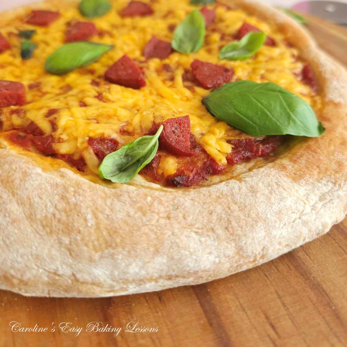 Extra close partial shot ofthe thick crust on a cheese and meat pizza.