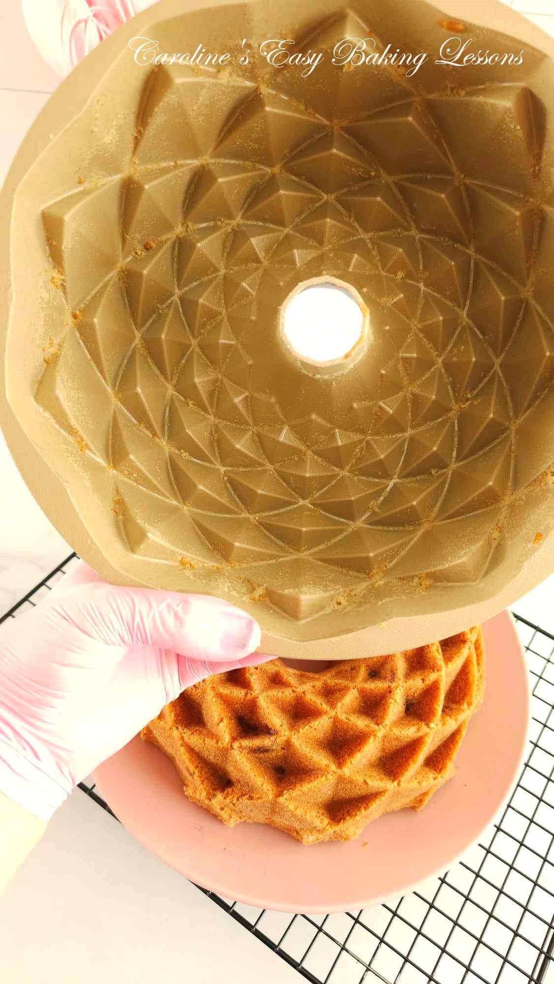 Close shot of the inside of a fancy bundt cake tin, showing tiny piece sof cake crumbs and the cake releasing well with homemade lining paste/cake goop.