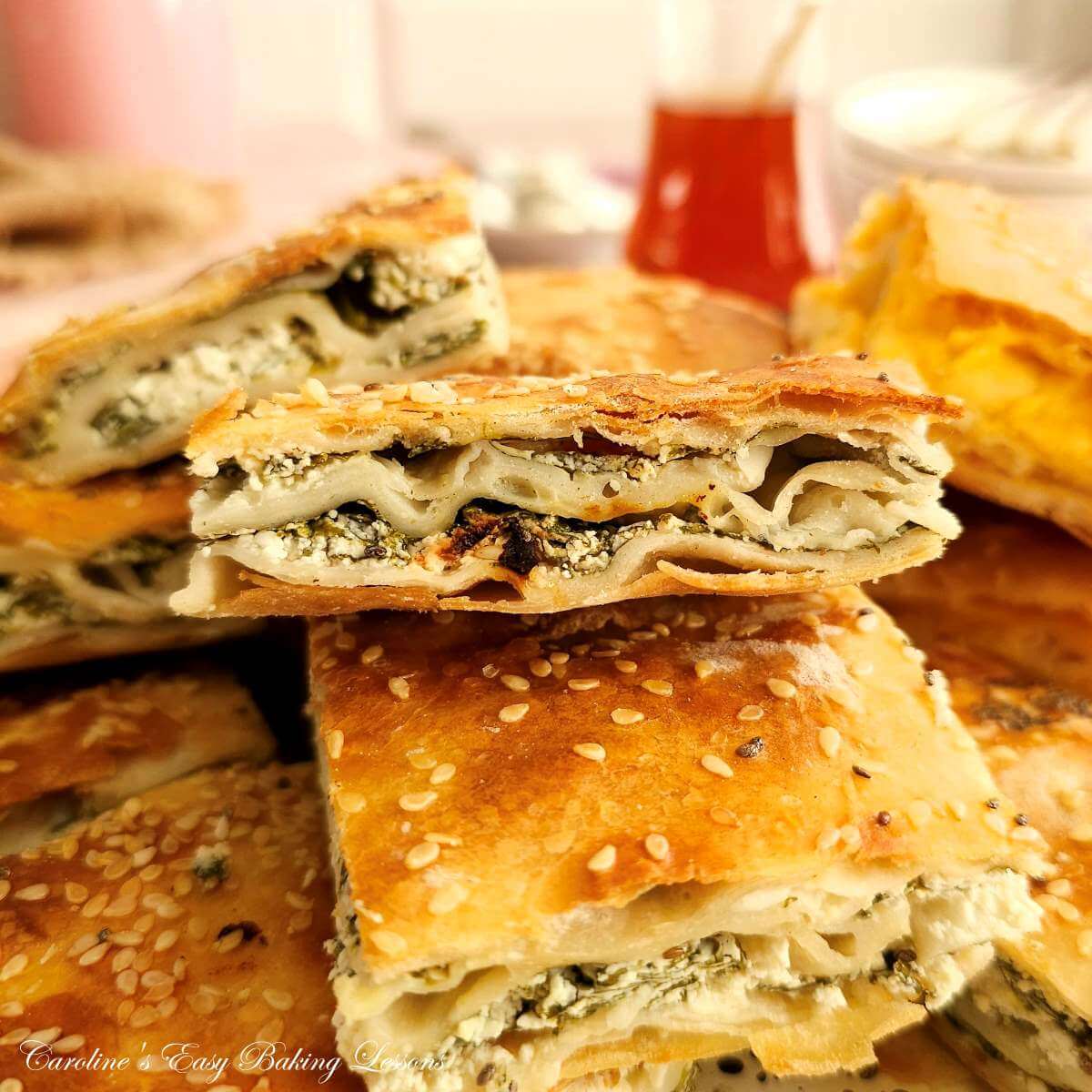Extra close shot of stack of Turkish cheese pastry Borek, showing layers & cheese spinach filling.