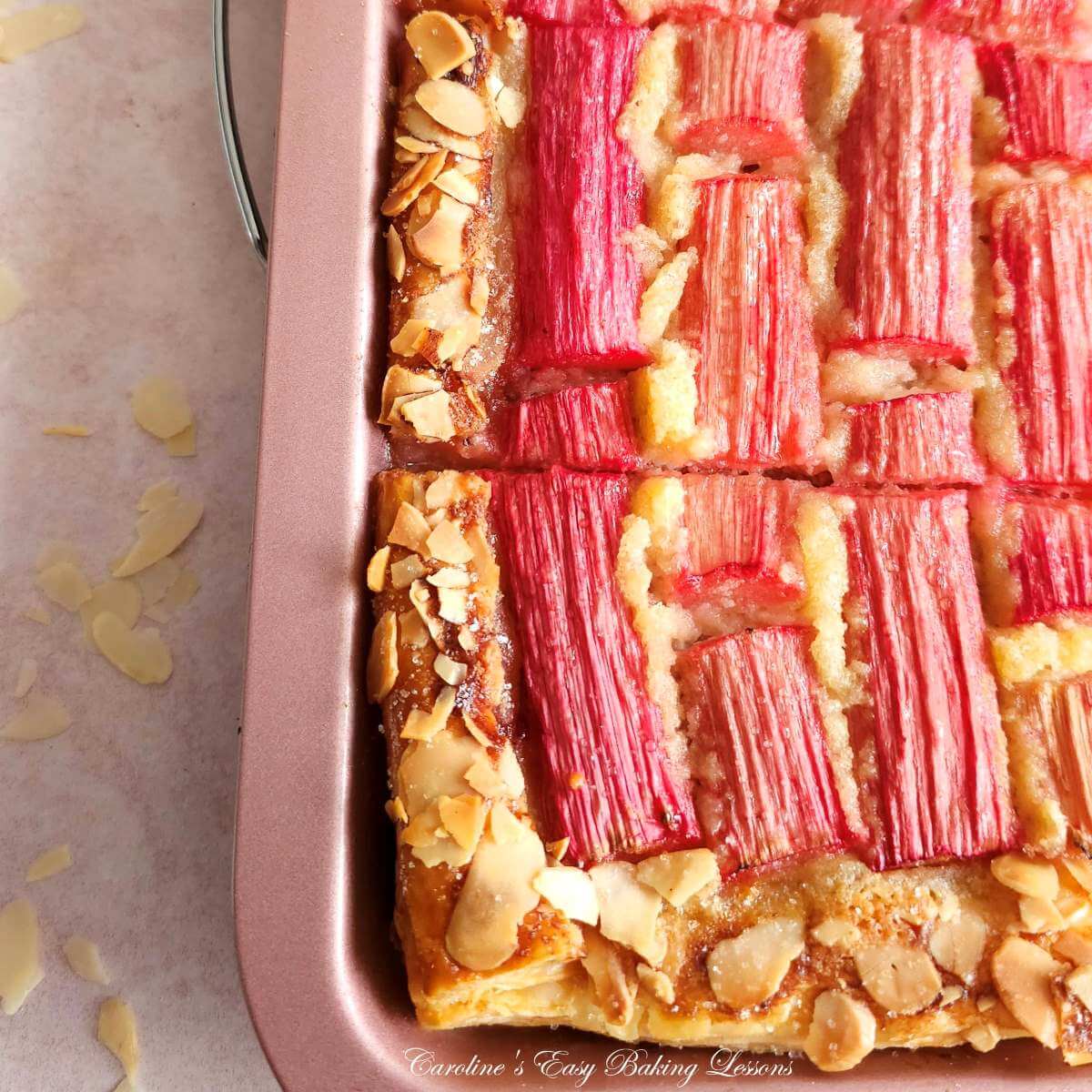 Extra close partial shot of a tray of rhuabr frangipane tart cooling.