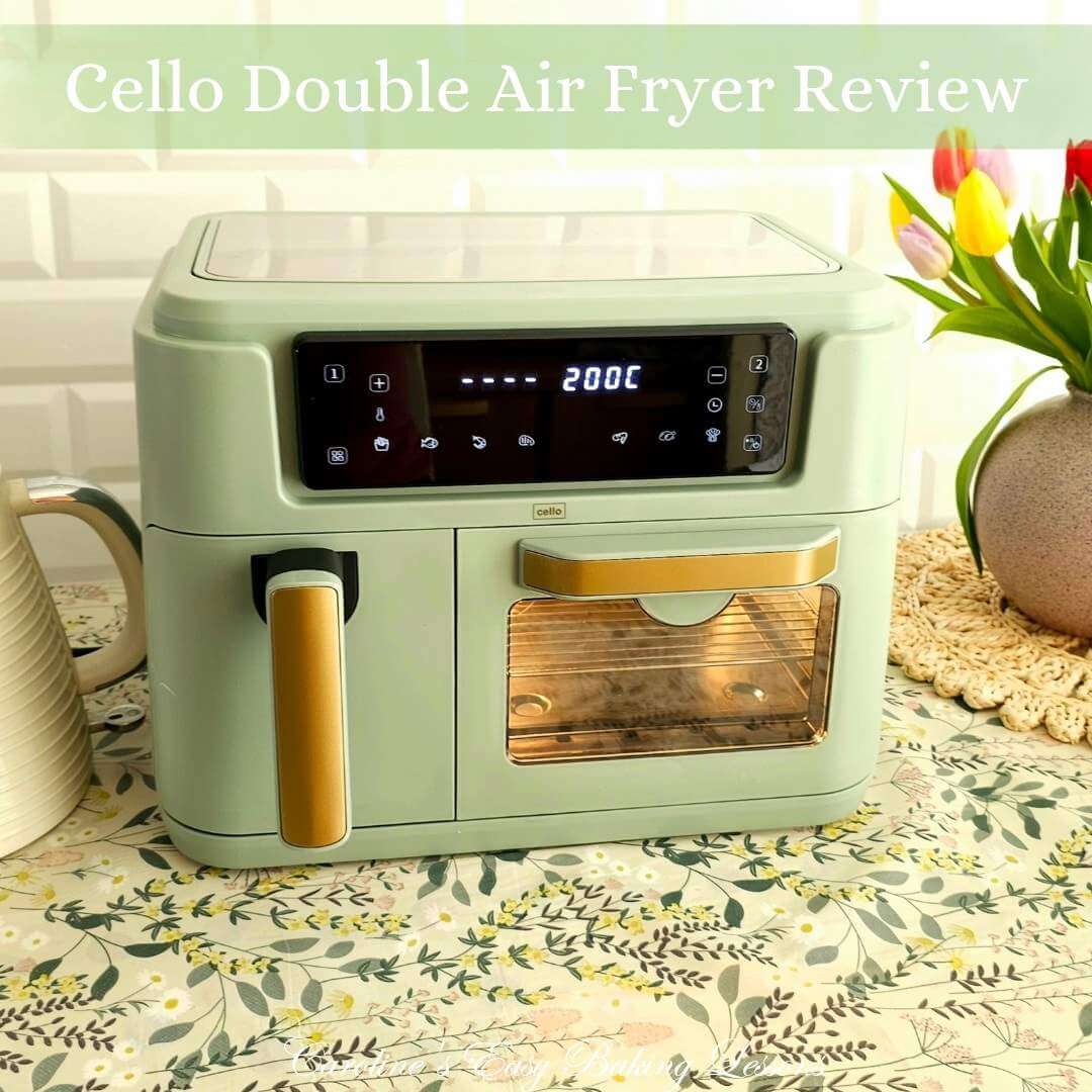 Photo of a sage green double air fryer by Cello with basket and oven cavity on a table with 'cello review' text.