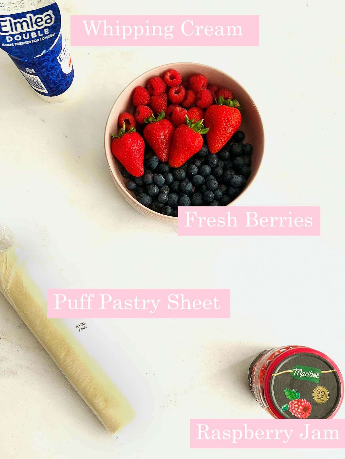 Labelled overhead shot of raspberry jam jar, puff pastry roll, whipping cream, for puff pastry cups.