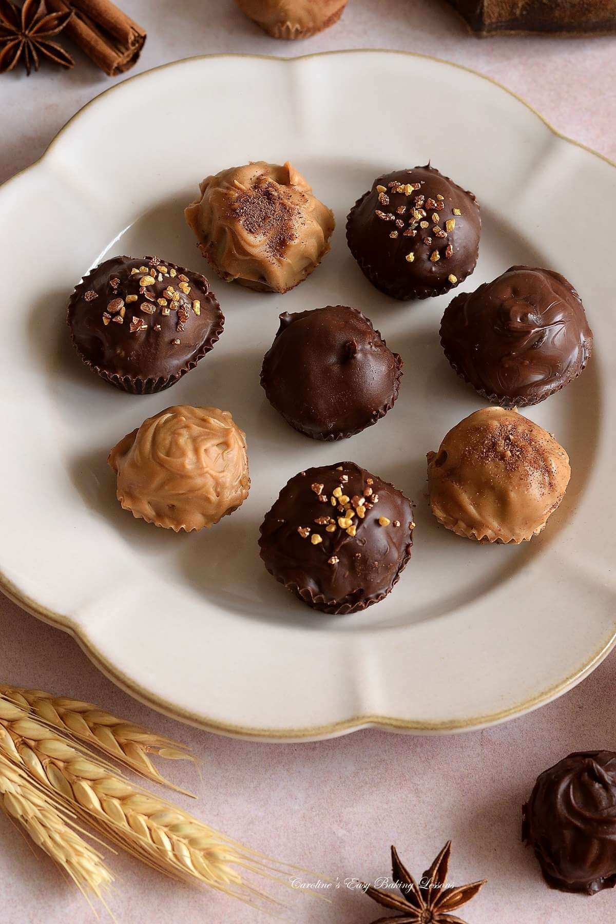 Close shot neutral scalloped plate with chocolate chai truffles.