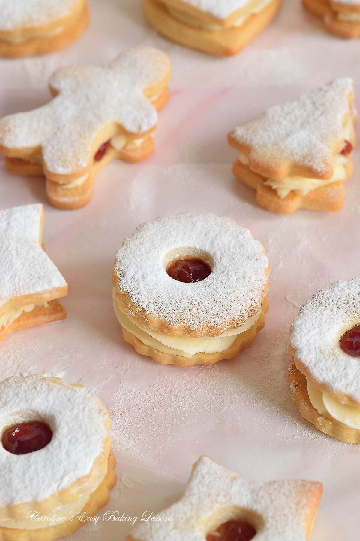 lose partial shot of sugar dusted jam and buttercream sandwich cookies (British Jammie Dodgers), on parchment paper.