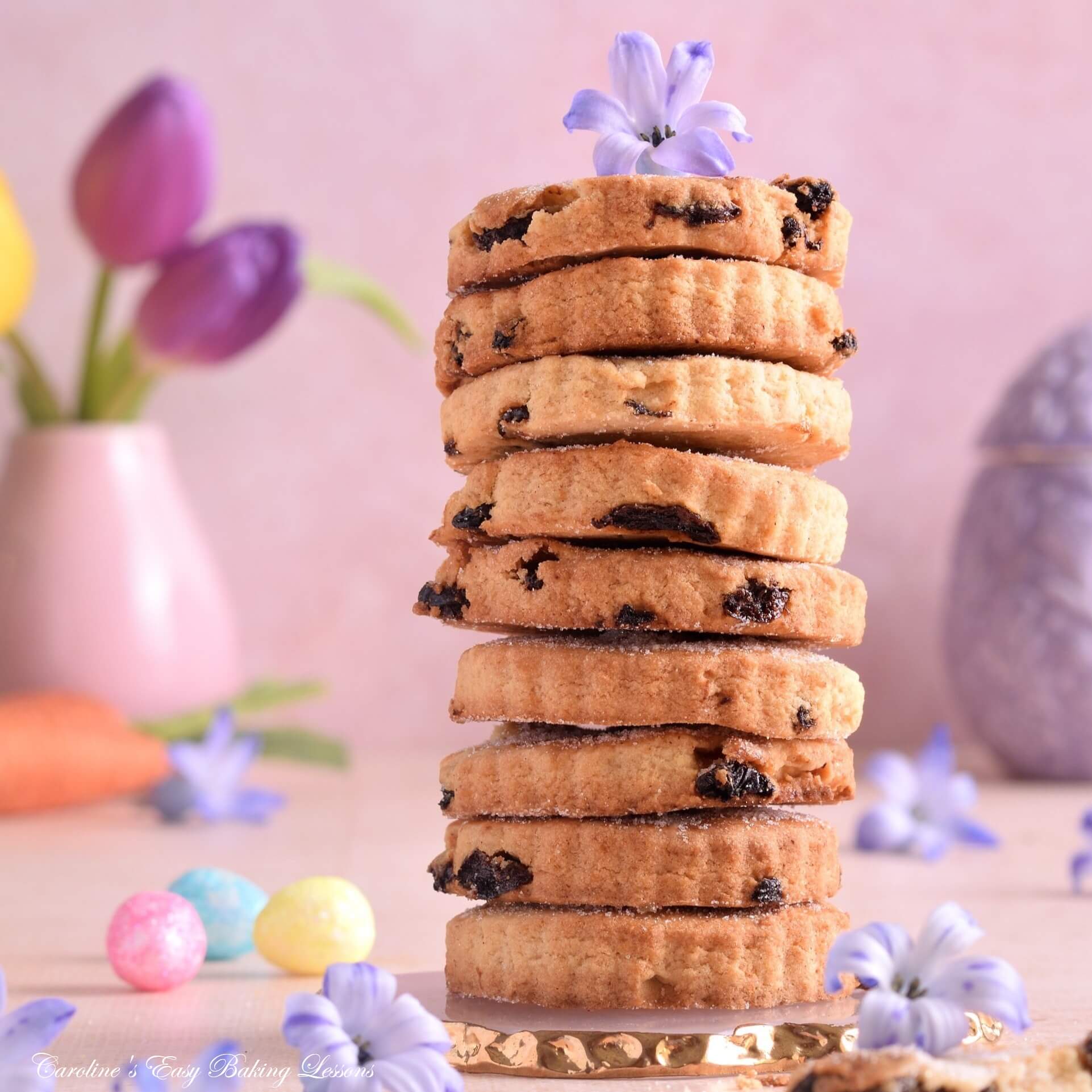 Close macro shot of a pastel and pink Easter shot of Easter biscuits/cookies, with hyacinth little lilac flowers and mini eggs.