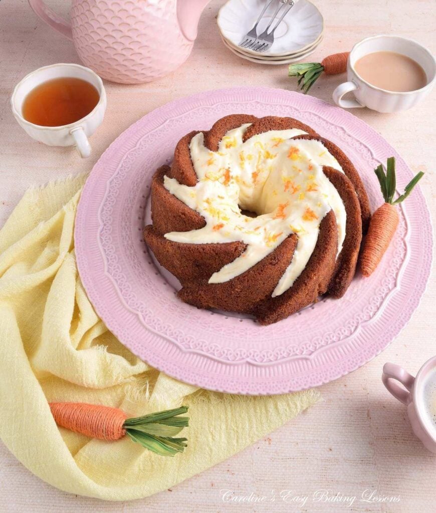 Photo of pastel coloured table with lenen and Easter decorations, with a gluten-free carrot bundt cake.