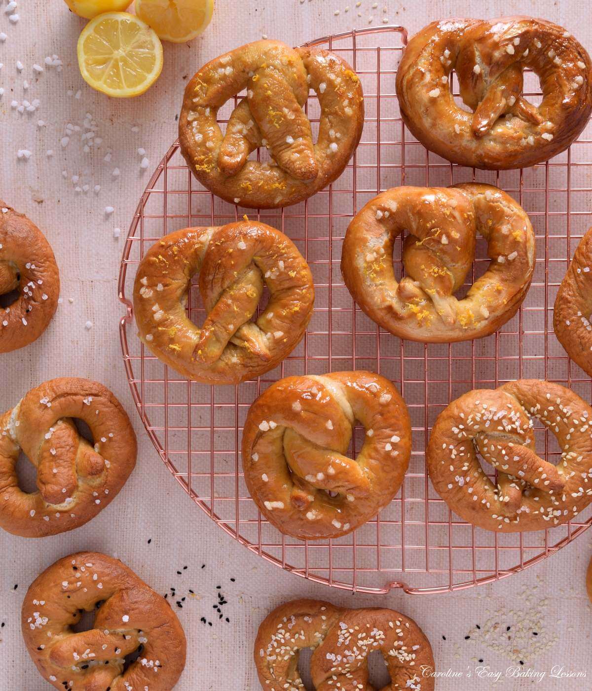 Overhead image of a round rose gold cooling rack, with homemade sweet abd savoury yest prezels on top.